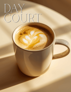 Golden honey almond latte with foam art in a ceramic mug, warm sunlight and soft shadows, ACOTAR Day Court inspired coffee drink